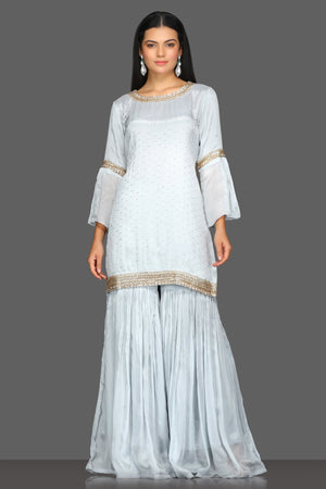 Buy beautiful light grey embroidered gharara suit online in USA with matching dupatta. Dazzle on weddings and special occasions with exquisite Indian designer dresses, sharara suits, Anarkali suits from Pure Elegance Indian fashion store in USA.-front