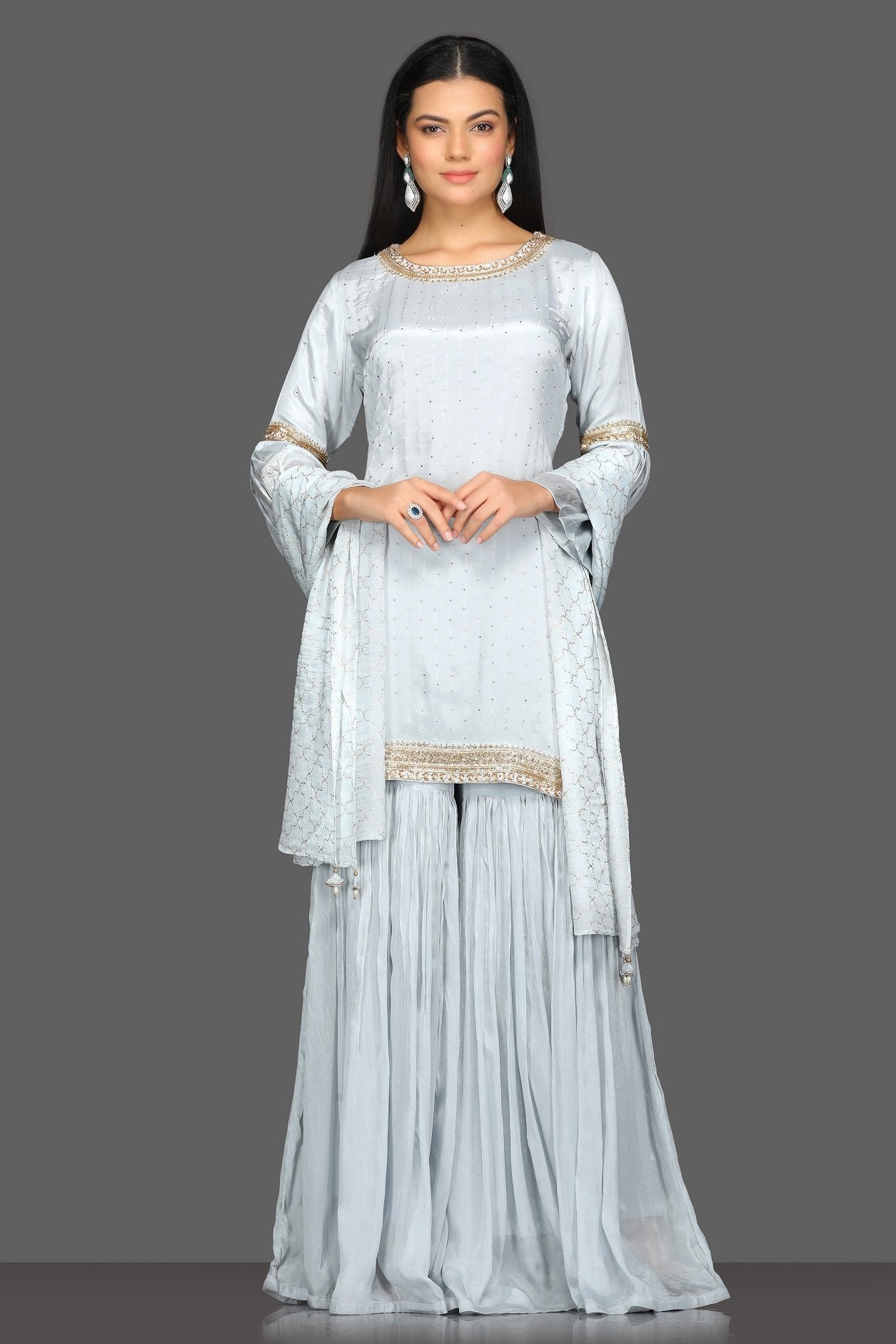 Buy beautiful light grey embroidered gharara suit online in USA with matching dupatta. Dazzle on weddings and special occasions with exquisite Indian designer dresses, sharara suits, Anarkali suits from Pure Elegance Indian fashion store in USA.-full view