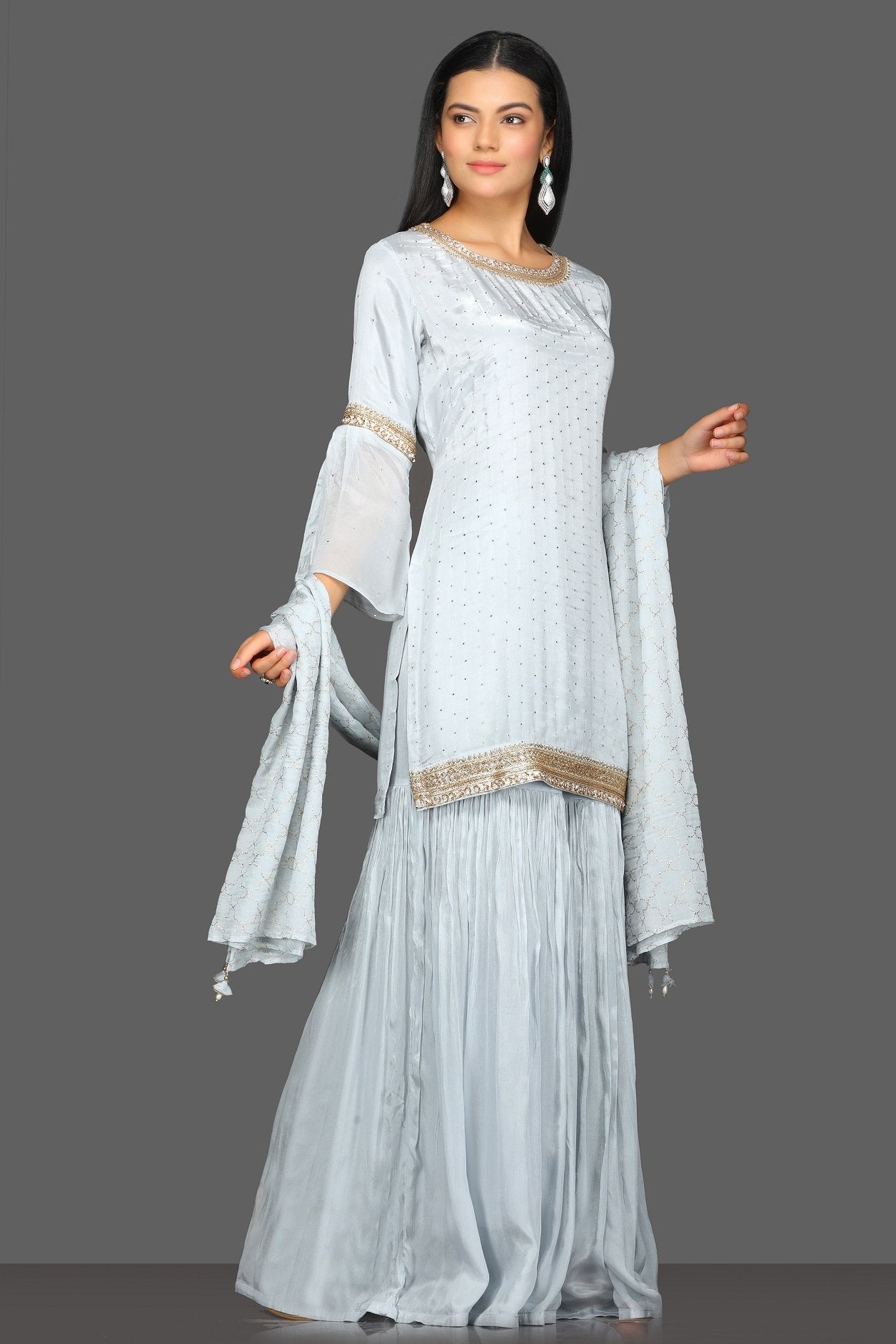 Buy beautiful light grey embroidered gharara suit online in USA with matching dupatta. Dazzle on weddings and special occasions with exquisite Indian designer dresses, sharara suits, Anarkali suits from Pure Elegance Indian fashion store in USA.-side
