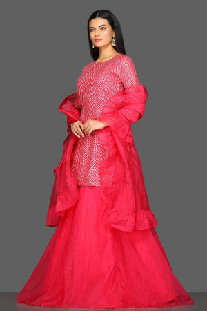 Shop pink embroidered skirt set online in USA with matching dupatta. Dazzle on weddings and special occasions with exquisite Indian designer dresses, sharara suits, Anarkali suits from Pure Elegance Indian fashion store in USA.-left