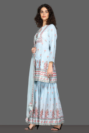 Shop beautiful powder blue floral gharara suit online in USA and matching dupatta. Dazzle on weddings and special occasions with exquisite Indian designer dresses, sharara suits, Anarkali suits from Pure Elegance Indian fashion store in USA.-left