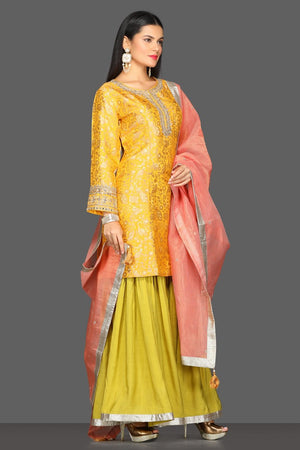 Buy yellow and green embroidered skirt set online in USA with pink dupatta. Dazzle on weddings and special occasions with exquisite Indian designer dresses, sharara suits, Anarkali suits from Pure Elegance Indian fashion store in USA.-side