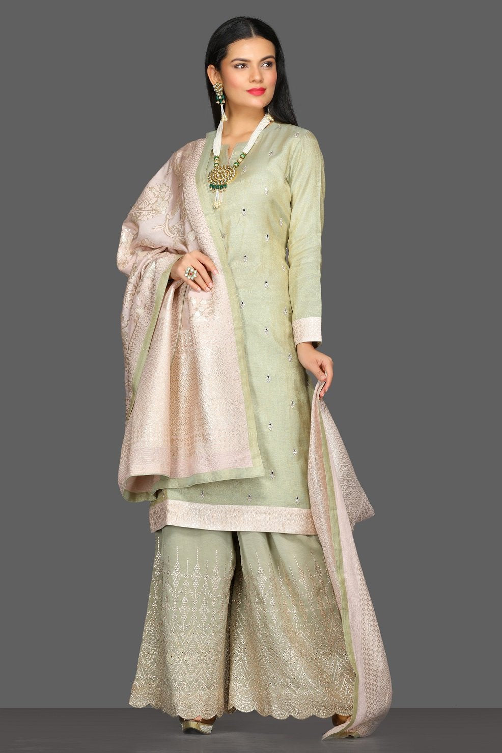 Buy beautiful pastel green embroidered palazzo suit online in USA with cream dupatta. Dazzle on weddings and special occasions with exquisite Indian designer dresses, sharara suits, Anarkali suits from Pure Elegance Indian fashion store in USA.-full view