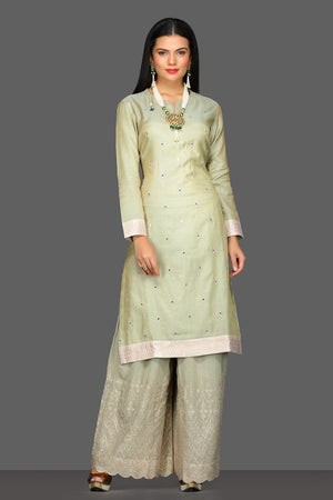 Buy beautiful pastel green embroidered palazzo suit online in USA with cream dupatta. Dazzle on weddings and special occasions with exquisite Indian designer dresses, sharara suits, Anarkali suits from Pure Elegance Indian fashion store in USA.-front