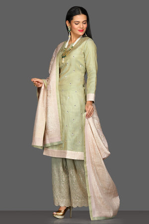 Buy beautiful pastel green embroidered palazzo suit online in USA with cream dupatta. Dazzle on weddings and special occasions with exquisite Indian designer dresses, sharara suits, Anarkali suits from Pure Elegance Indian fashion store in USA.-side