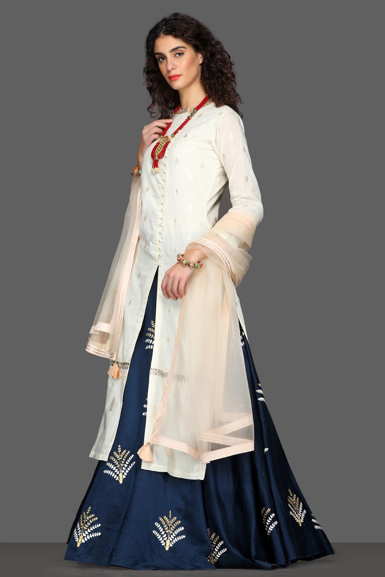 Buy elegant embroidered kurta with navy skirt online in USA and cream dupatta. Dazzle on weddings and special occasions with exquisite Indian designer lehengas, sharara suits, Anarkali suits from Pure Elegance Indian fashion store in USA.-left