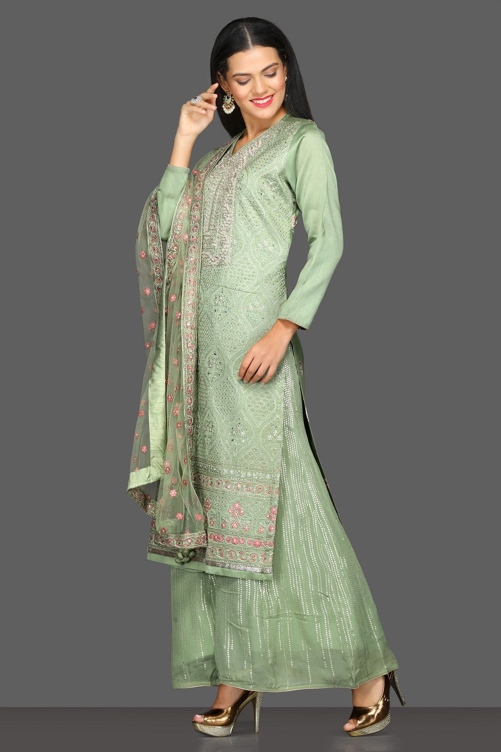 Buy beautiful pista green embroidered suit online in USA with palazzo and embroidered dupatta. Dazzle on weddings and special occasions with exquisite Indian designer lehengas, sharara suits, Anarkali suits from Pure Elegance Indian fashion store in USA.-left