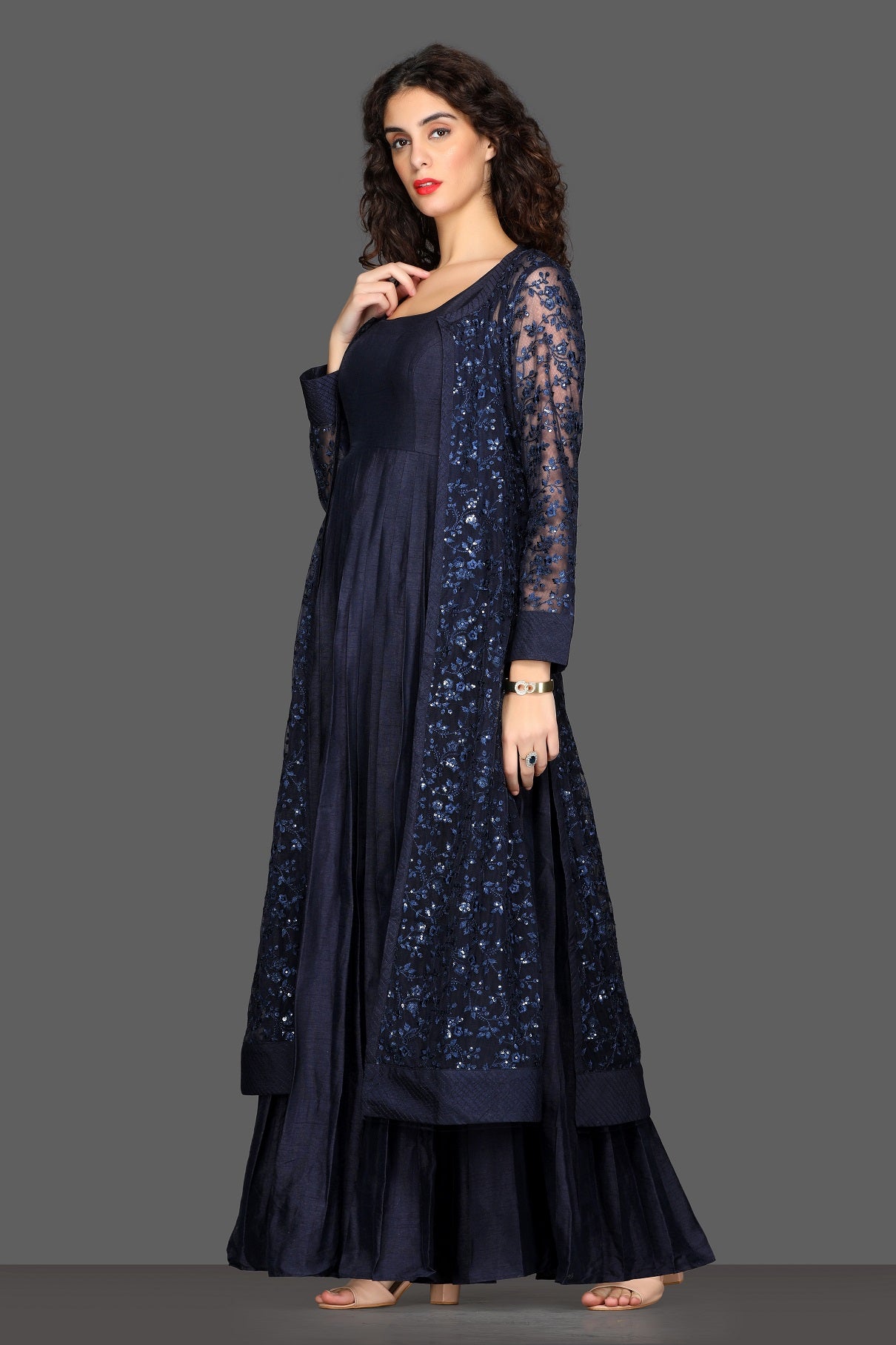 Shop navy blue maxi dress online in USA with long embroidered shrug. Dazzle on weddings and special occasions with exquisite Indian designer lehengas, sharara suits, Anarkali suits, Indowestern dresses from Pure Elegance Indian fashion store in USA.-left