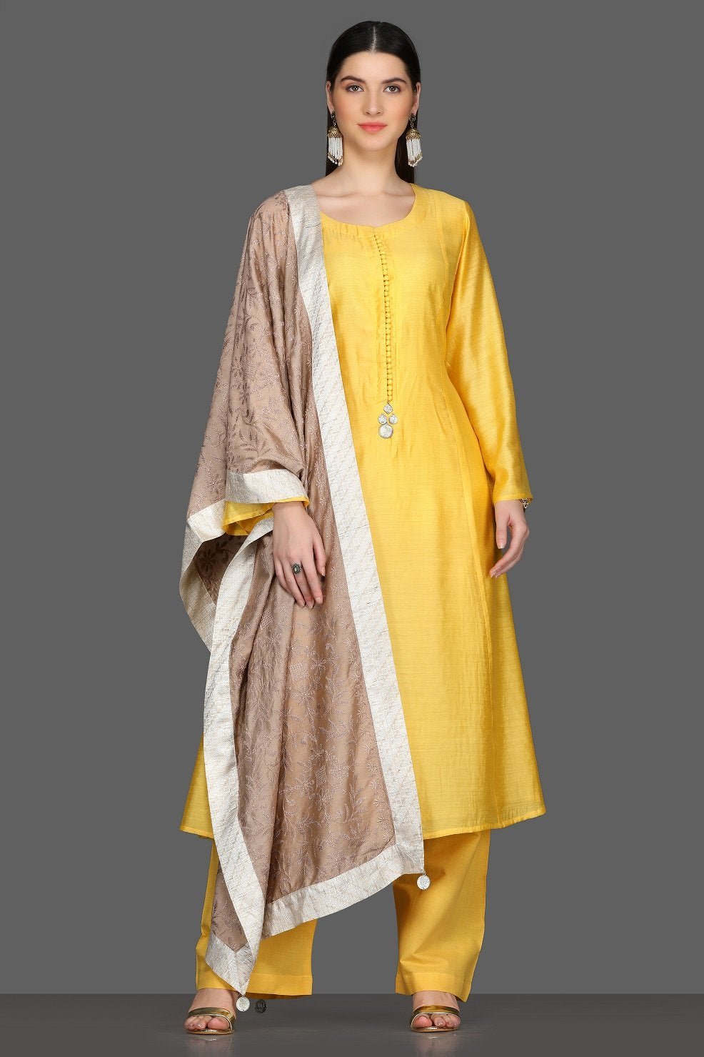 Buy elegant solid yellow palazzo suit online in USA with beige dupatta. Dazzle on weddings and special occasions with exquisite Indian designer dresses, sharara suits, Anarkali suits from Pure Elegance Indian fashion store in USA.-full view