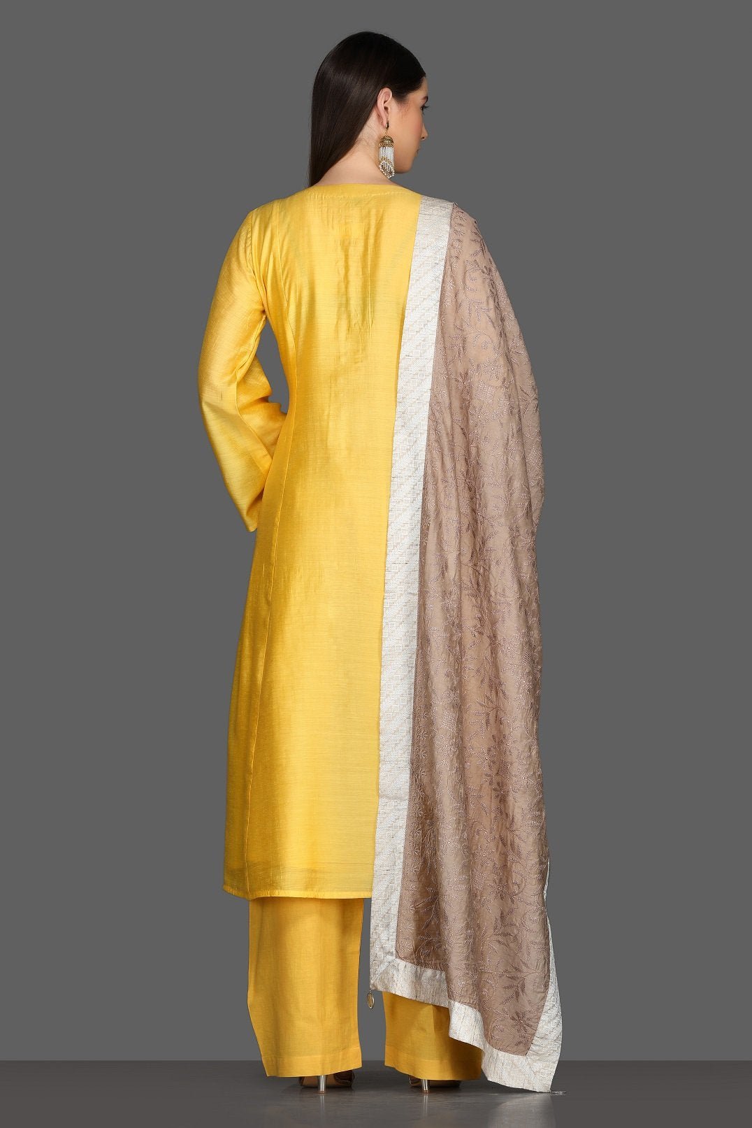 Buy elegant solid yellow palazzo suit online in USA with beige dupatta. Dazzle on weddings and special occasions with exquisite Indian designer dresses, sharara suits, Anarkali suits from Pure Elegance Indian fashion store in USA.-back