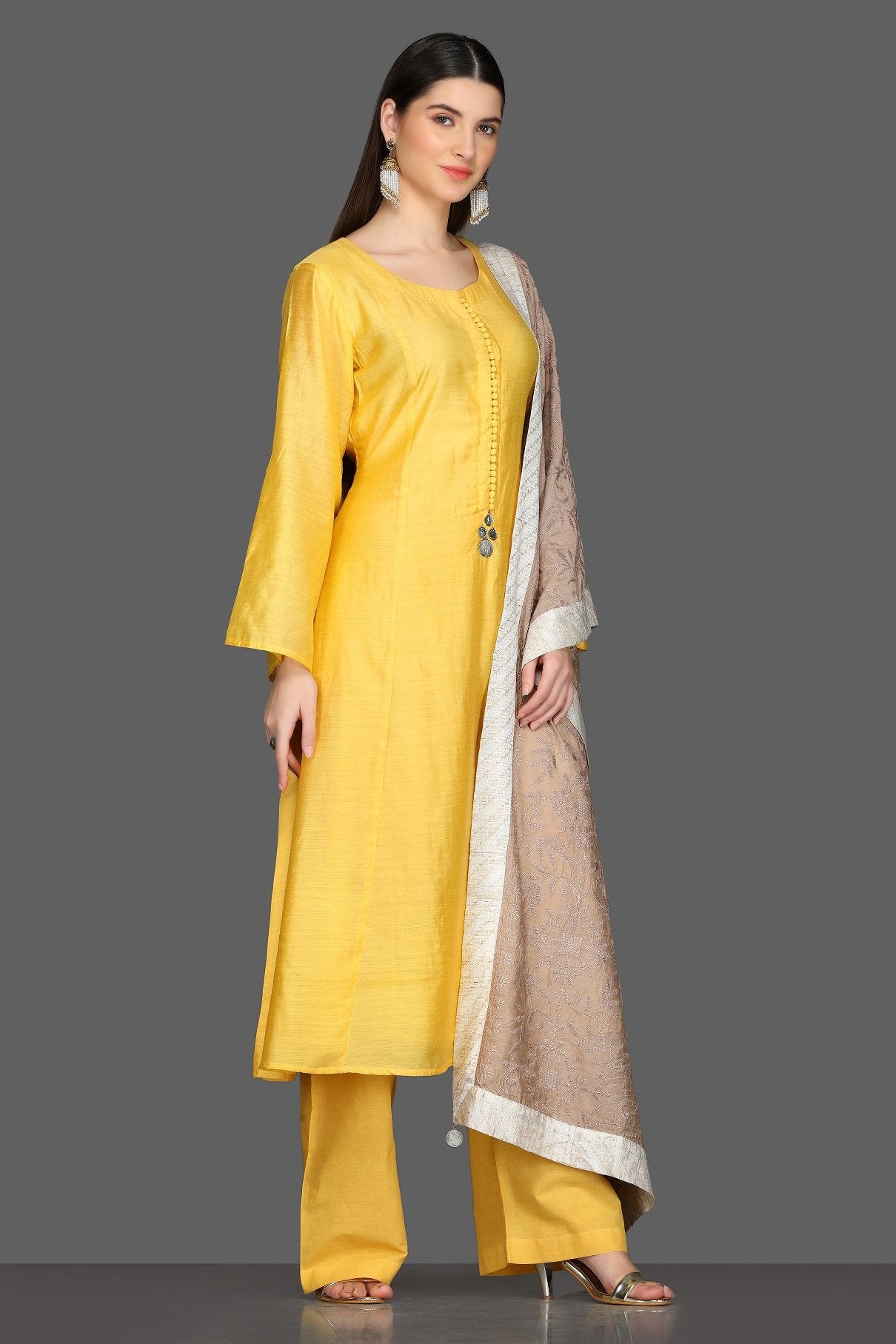 Buy elegant solid yellow palazzo suit online in USA with beige dupatta. Dazzle on weddings and special occasions with exquisite Indian designer dresses, sharara suits, Anarkali suits from Pure Elegance Indian fashion store in USA.-right