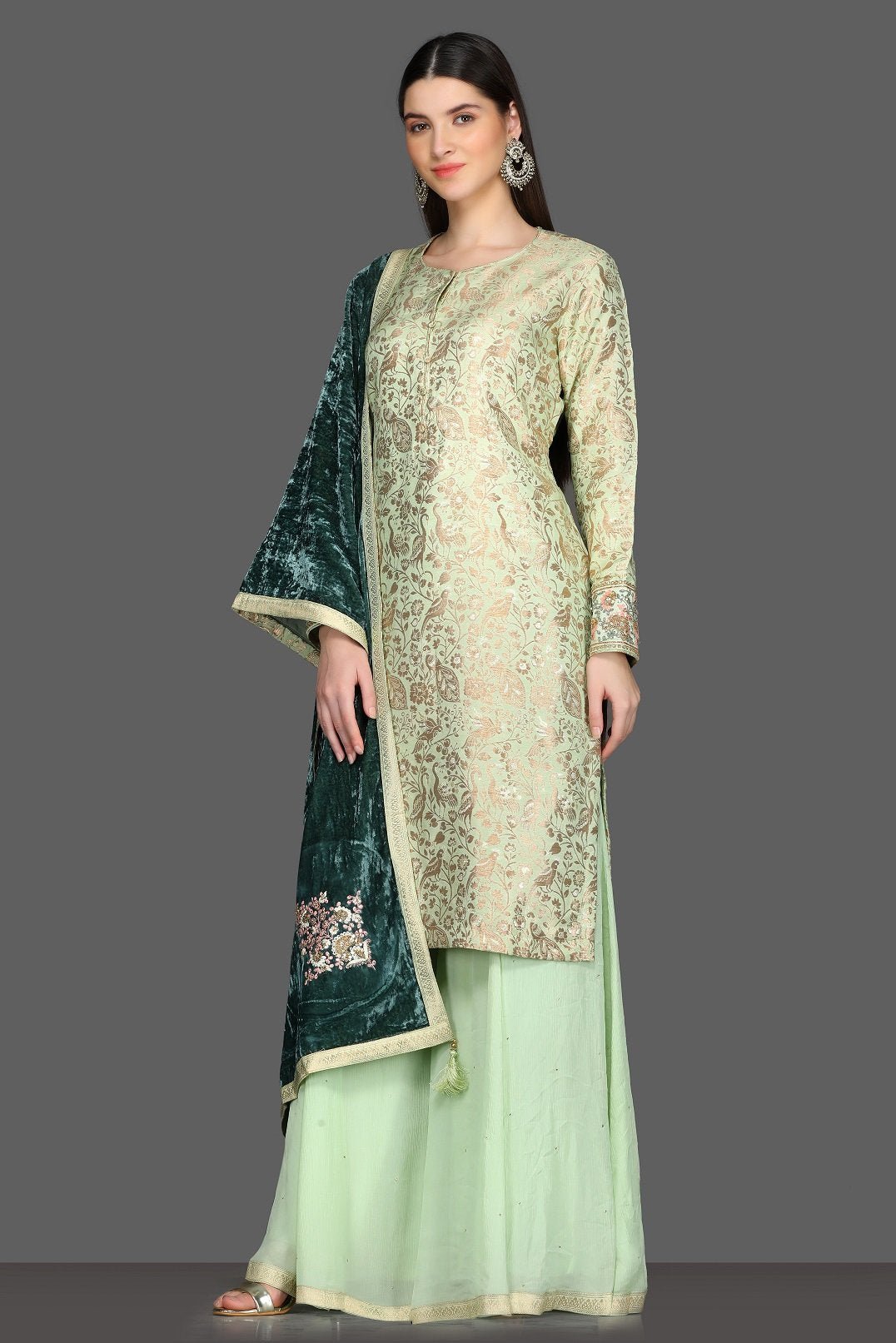 Shop beautiful mint green palazzo suit online in USA with green velvet dupatta. Dazzle on weddings and special occasions with exquisite Indian designer dresses, sharara suits, Anarkali suits from Pure Elegance Indian fashion store in USA.-left