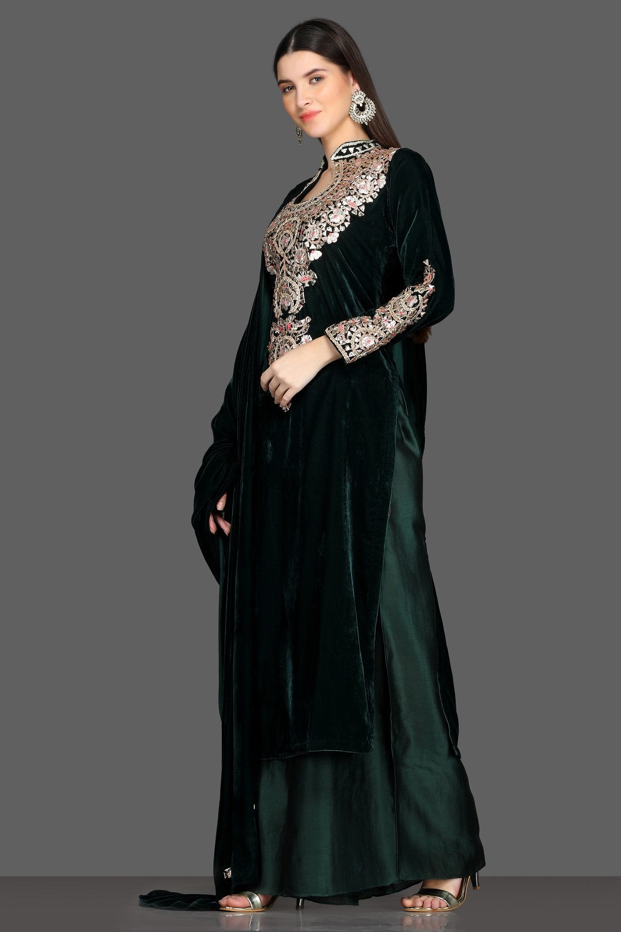 Buy gorgeous bottle green embroidered velvet palazzo suit online in USA with dupatta. Dazzle on weddings and special occasions with exquisite Indian designer lehengas, sharara suits, Anarkali suits, Indowestern dresses from Pure Elegance Indian fashion store in USA.-left