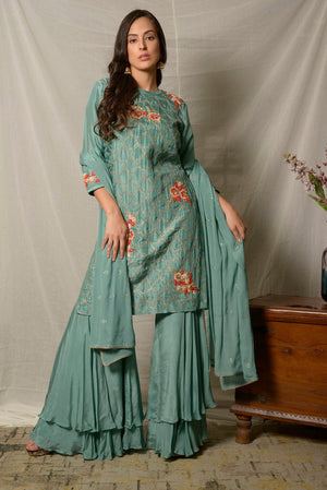 Buy gorgeous dark aqua embroidered Uppada silk suit online in USA with dupatta. Shine at weddings and special occasions with beautiful Indian designer suits, gowns, lehengas from Pure Elegance Indian clothing store in USA.-front