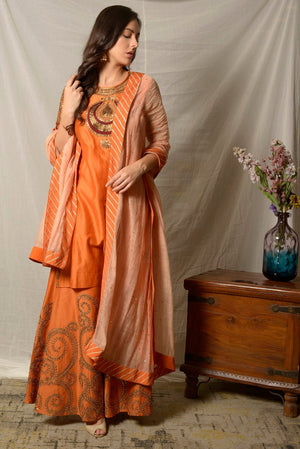 Buy stunning burnt orange embroidered chanderi sharara suit online in USA with dupatta. Shine at weddings and special occasions with beautiful Indian designer suits, gowns, lehengas from Pure Elegance Indian clothing store in USA.-right side