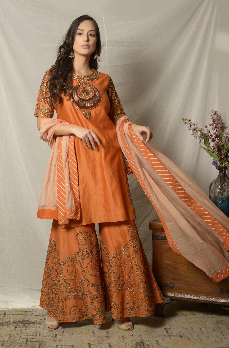 Buy stunning burnt orange embroidered chanderi sharara suit online in USA with dupatta. Shine at weddings and special occasions with beautiful Indian designer suits, gowns, lehengas from Pure Elegance Indian clothing store in USA.-suit