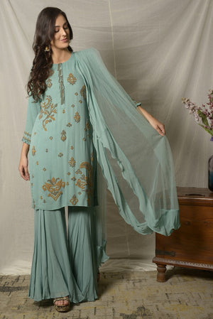 Shop elegant dark aqua embroidered georgette sharara suit online in USA with dupatta. Shine at weddings and special occasions with beautiful Indian designer suits, gowns, lehengas from Pure Elegance Indian clothing store in USA.-side