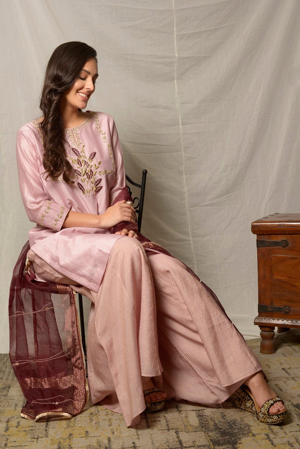 Buy alluring dull mauve gota work chanderi suit online in USA with maroon dupatta and matching palazzo. Shine at weddings and special occasions with beautiful Indian designer suits, gowns, lehengas from Pure Elegance Indian clothing store in USA.-side pose