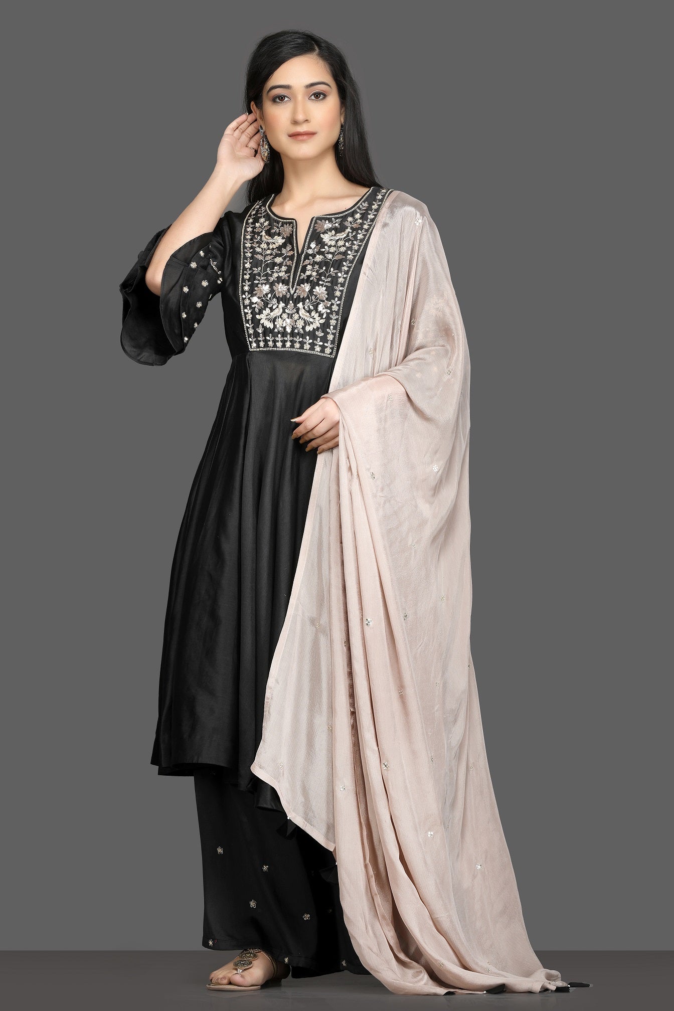 Buy elegant black embroidered flared palazzo suit online in USA with dusty pink dupatta. Dazzle on weddings and special occasions with exquisite Indian designer dresses, sharara suits, Anarkali suits, bridal lehegas from Pure Elegance Indian fashion store in USA.-full view