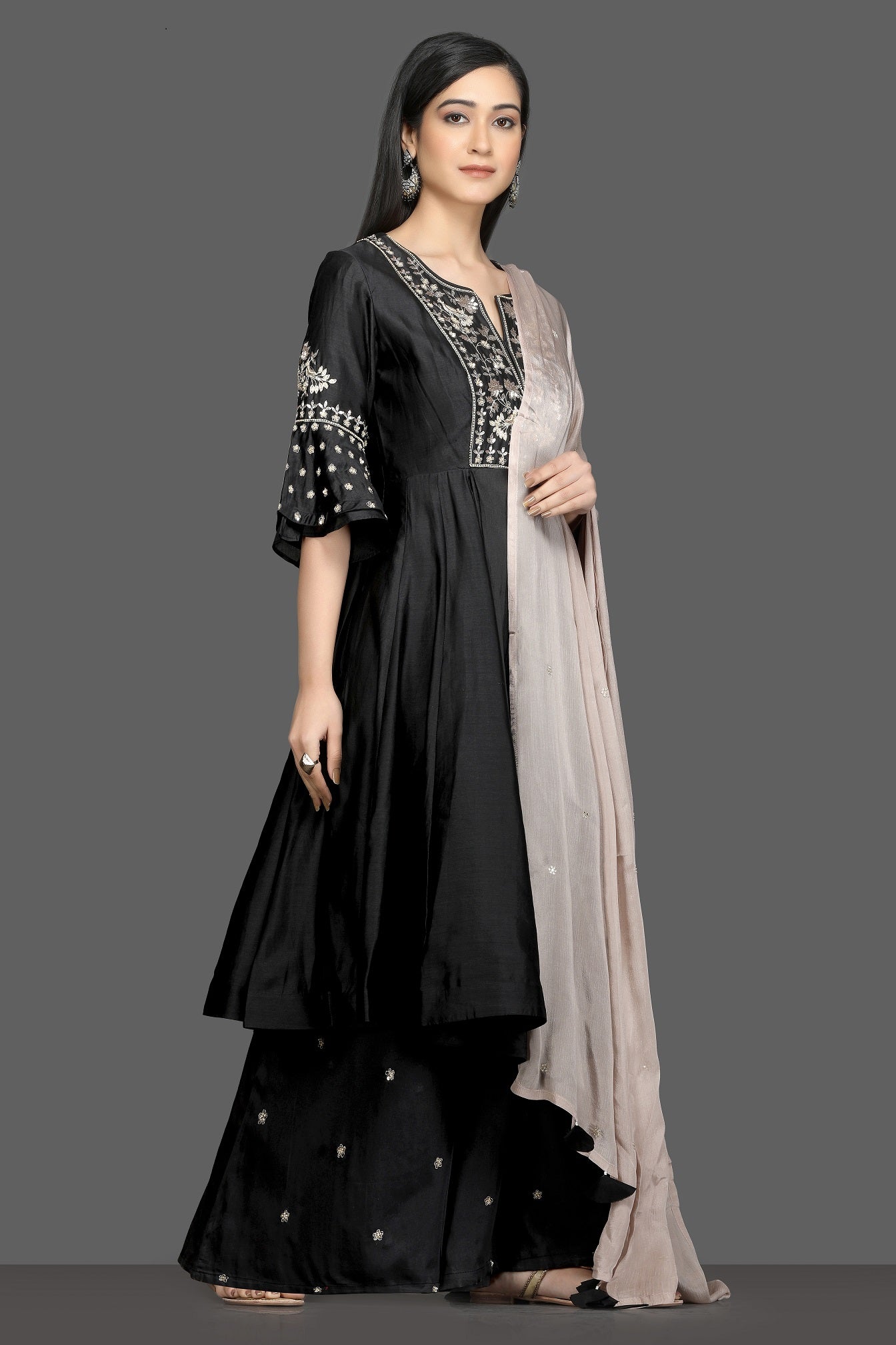Buy elegant black embroidered flared palazzo suit online in USA with dusty pink dupatta. Dazzle on weddings and special occasions with exquisite Indian designer dresses, sharara suits, Anarkali suits, bridal lehegas from Pure Elegance Indian fashion store in USA.-side