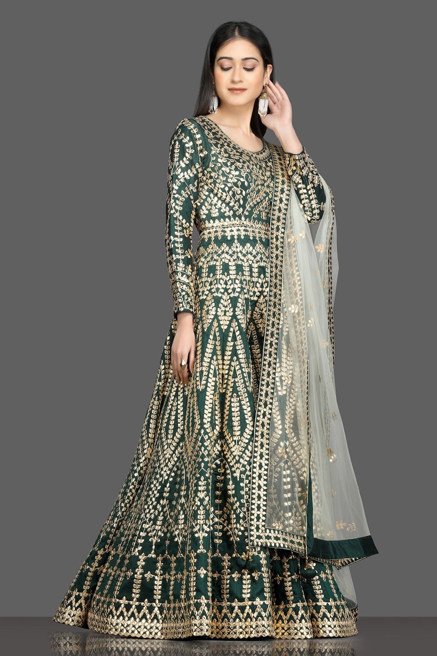 Shop beautiful dark green gota work Anarkali online in USA with net dupatta. Dazzle on weddings and special occasions with exquisite Indian designer dresses, sharara suits, Anarkali suits, bridal lehegas from Pure Elegance Indian fashion store in USA.-right