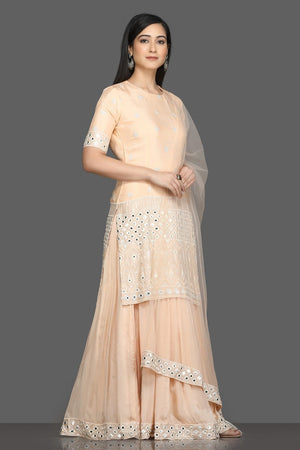 Shop elegant peach embroidered lehenga online in USA with dupatta. Dazzle on weddings and special occasions with exquisite Indian designer dresses, sharara suits, Anarkali suits, bridal lehengas from Pure Elegance Indian fashion store in USA.-right