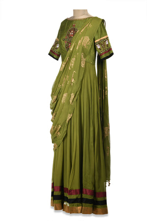 Shop beautiful green embroidered maxi dress online in USA with draped dupatta. Shine at weddings and special occasions with beautiful Indian designer Anarkali suits, traditional salwar suits, sharara suits, designer lehengas from Pure Elegance Indian clothing store in USA.-side