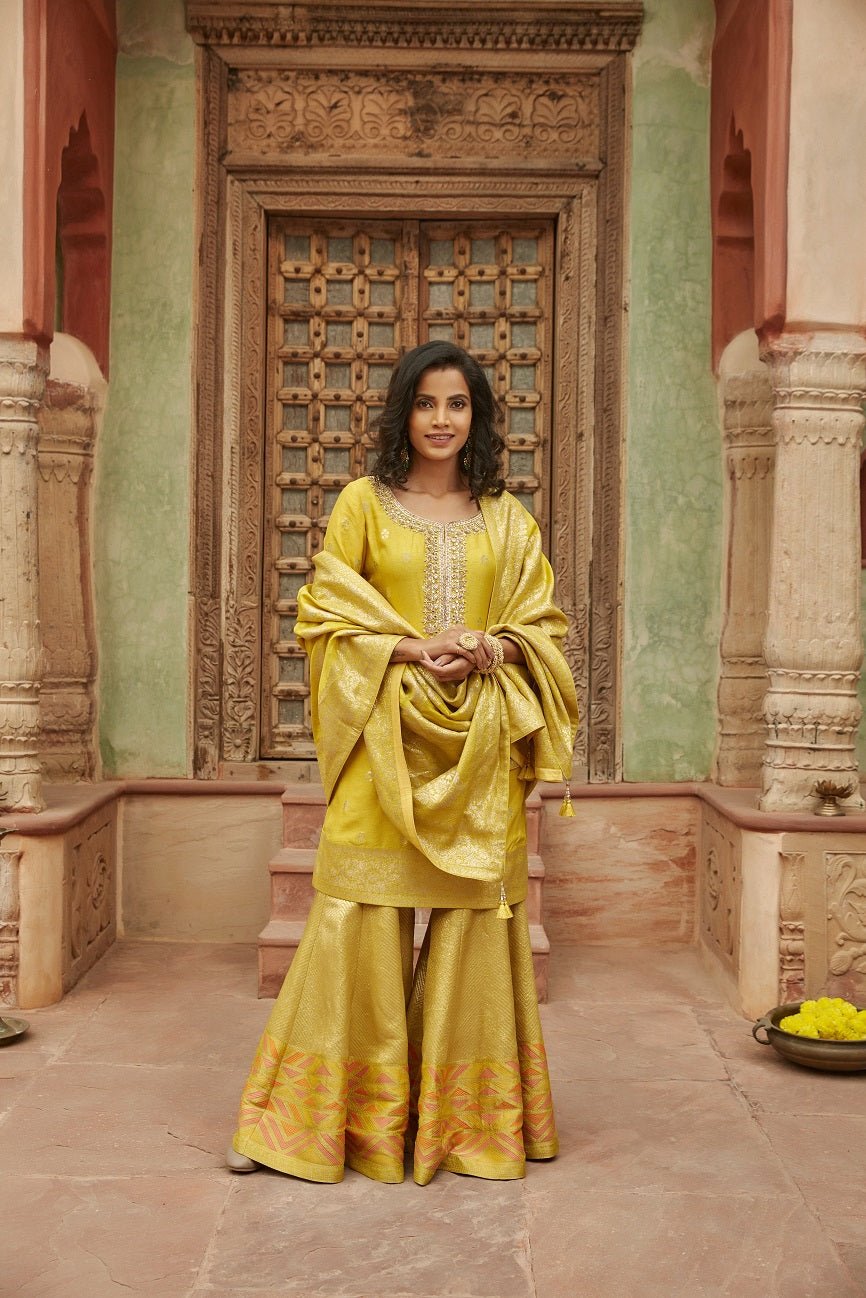 Buy stunning yellow mirror embroidery Banarasi sharara suit online in USA with dupatta. Elevate your ethnic style with a tasteful collection of designer Anarkali, designer salwar suits, designer lehengas, sharara suits from Pure Elegance Indian clothing store in USA.-front