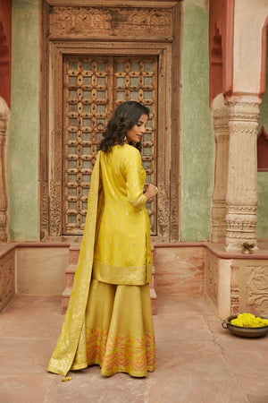 Buy stunning yellow mirror embroidery Banarasi sharara suit online in USA with dupatta. Elevate your ethnic style with a tasteful collection of designer Anarkali, designer salwar suits, designer lehengas, sharara suits from Pure Elegance Indian clothing store in USA.-back