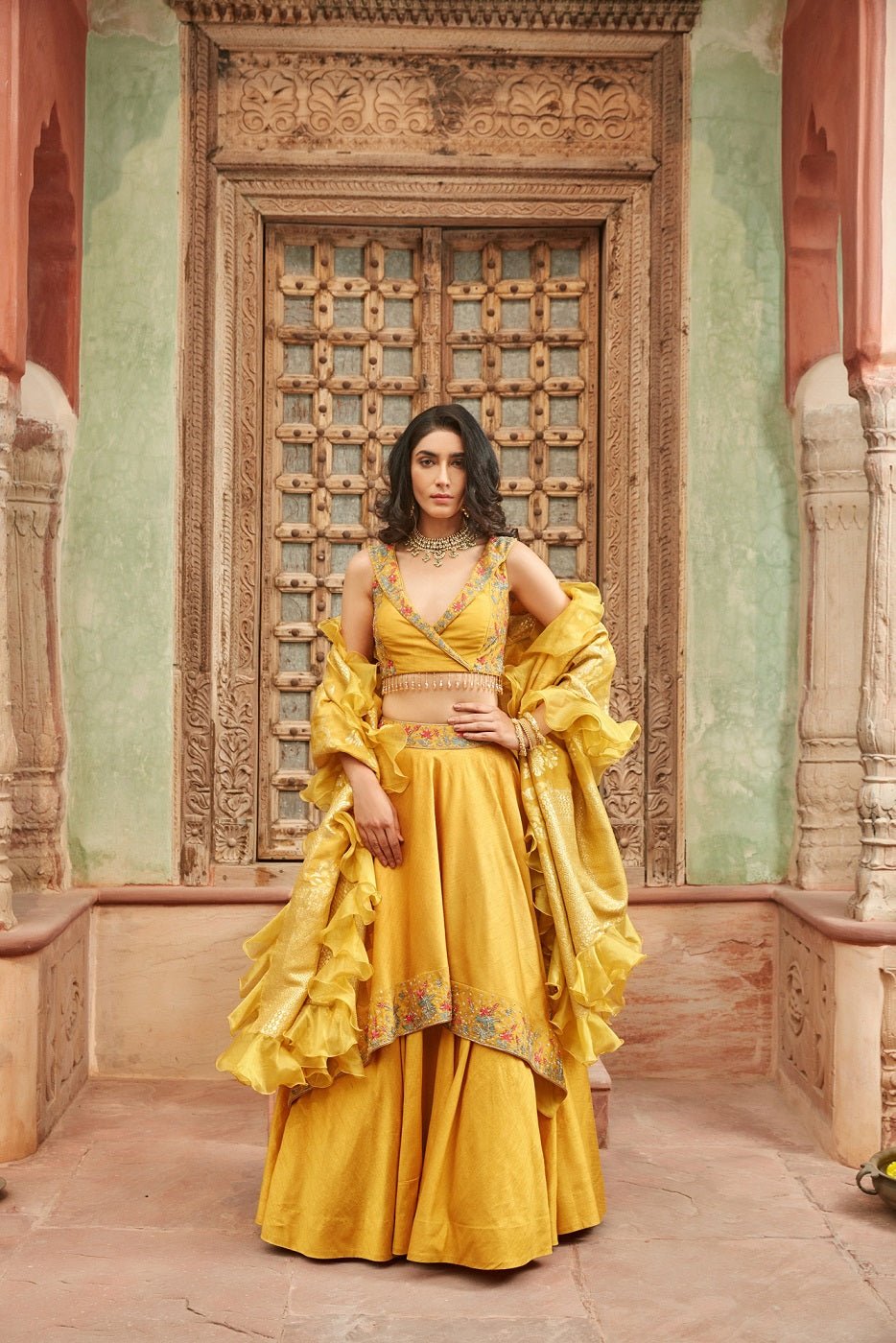 Shop gorgeous yellow embroidered raw silk lehenga online in USA with dupatta. Elevate your ethnic style with a tasteful collection of designer Anarkali, designer salwar suits, designer lehengas, sharara suits from Pure Elegance Indian clothing store in USA.-full view