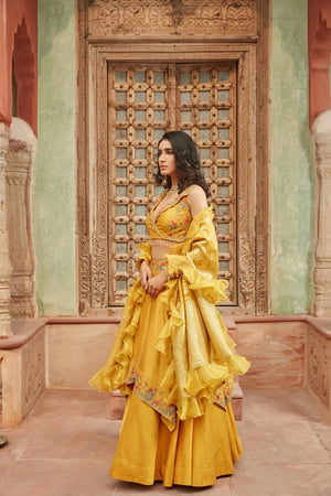 Shop gorgeous yellow embroidered raw silk lehenga online in USA with dupatta. Elevate your ethnic style with a tasteful collection of designer Anarkali, designer salwar suits, designer lehengas, sharara suits from Pure Elegance Indian clothing store in USA.-side