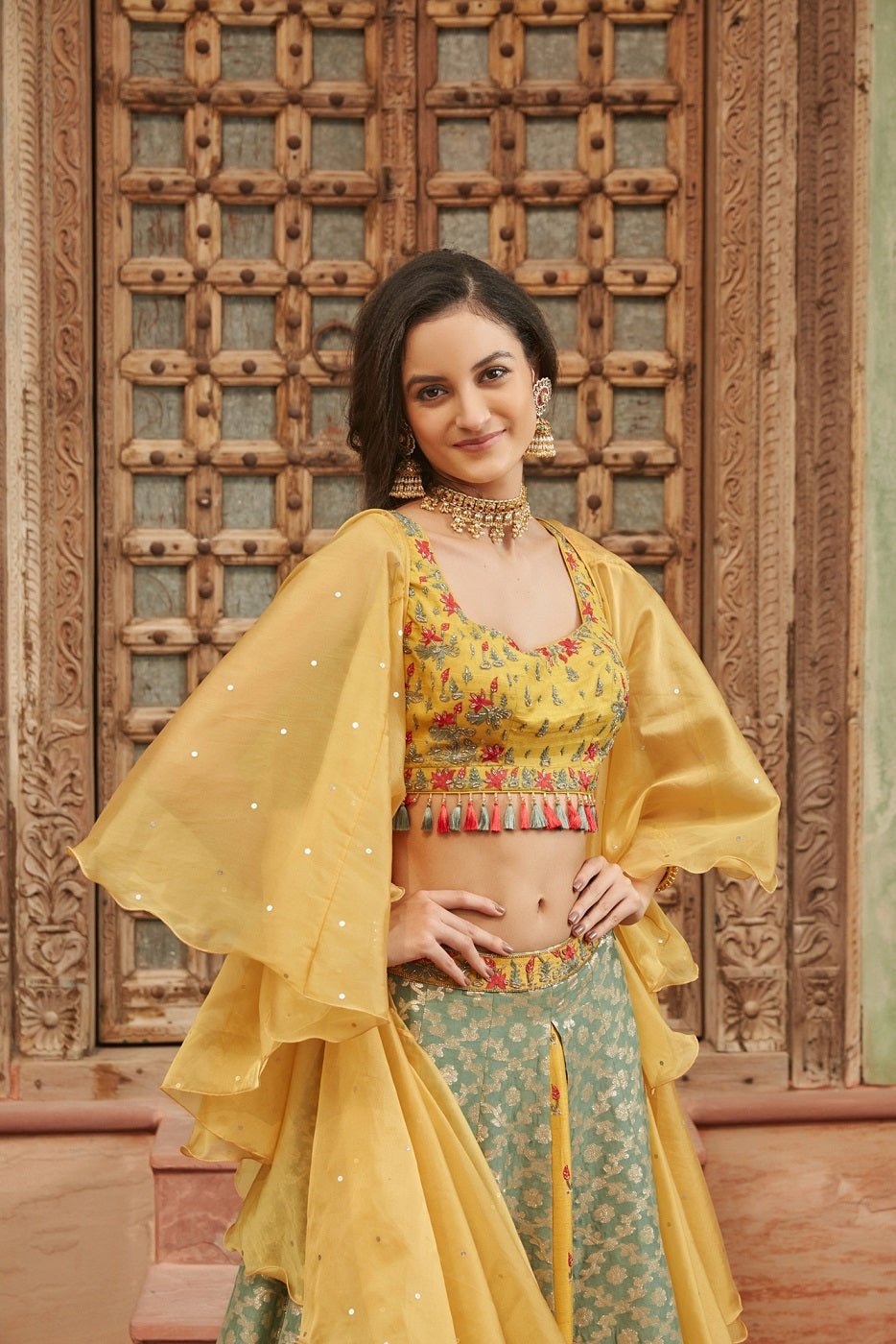 Shop beautiful yellow and green embroidered Banarasi lehenga online in USA with dupatta. Elevate your ethnic style with a tasteful collection of designer Anarkali, designer salwar suits, designer lehengas, sharara suits from Pure Elegance Indian clothing store in USA.-closeup