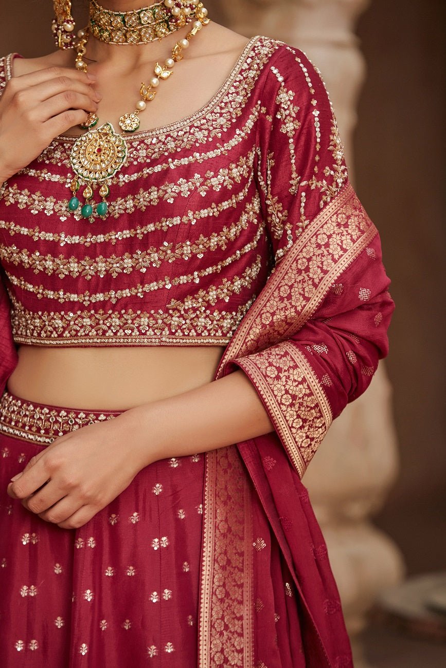 Shop beautiful maroon embroidered Banarasi lehenga online in USA with dupatta. Elevate your ethnic style with a tasteful collection of designer Anarkali, designer salwar suits, designer lehengas, sharara suits from Pure Elegance Indian clothing store in USA.-closeup