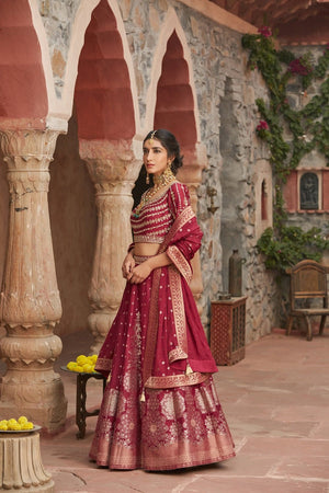 Shop beautiful maroon embroidered Banarasi lehenga online in USA with dupatta. Elevate your ethnic style with a tasteful collection of designer Anarkali, designer salwar suits, designer lehengas, sharara suits from Pure Elegance Indian clothing store in USA.-side