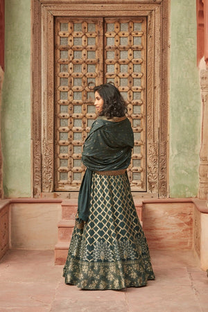 Buy stunning dark green embroidered Banarasi lehenga online in USA with dupatta. Elevate your ethnic style with a tasteful collection of designer Anarkali, designer salwar suits, designer lehengas, sharara suits from Pure Elegance Indian clothing store in USA.-back