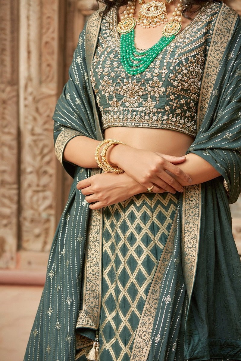 Buy stunning dark green embroidered Banarasi lehenga online in USA with dupatta. Elevate your ethnic style with a tasteful collection of designer Anarkali, designer salwar suits, designer lehengas, sharara suits from Pure Elegance Indian clothing store in USA.-closeup