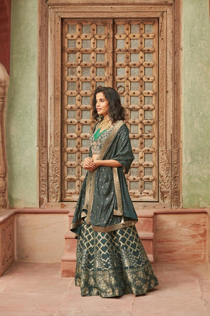 Buy stunning dark green embroidered Banarasi lehenga online in USA with dupatta. Elevate your ethnic style with a tasteful collection of designer Anarkali, designer salwar suits, designer lehengas, sharara suits from Pure Elegance Indian clothing store in USA.-side