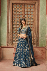 Shop gorgeous blue embroidered Banarasi lehenga online in USA with dupatta. Elevate your ethnic style with a tasteful collection of designer Anarkali, designer salwar suits, designer lehengas, sharara suits from Pure Elegance Indian clothing store in USA.-full view