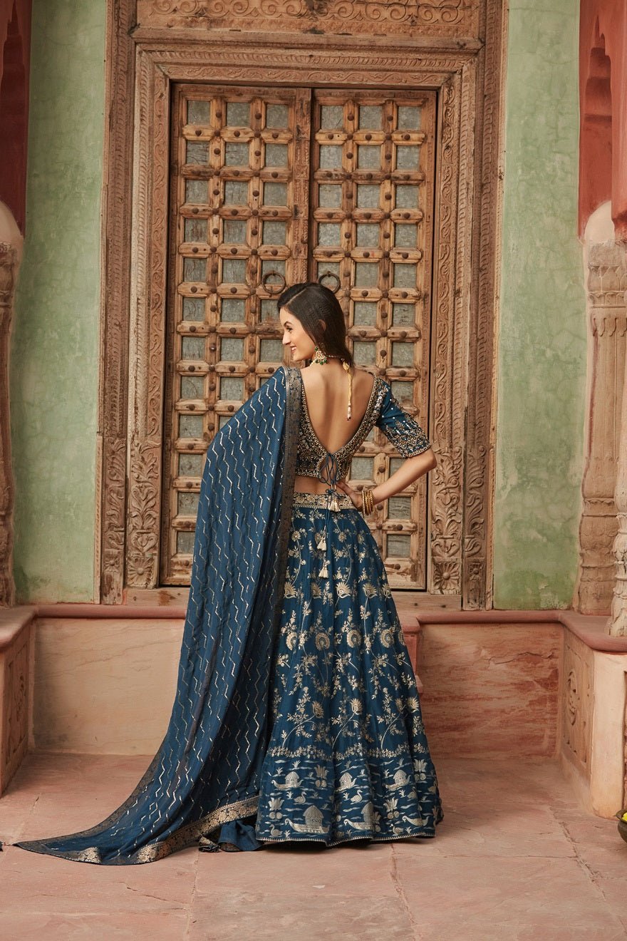 Shop gorgeous blue embroidered Banarasi lehenga online in USA with dupatta. Elevate your ethnic style with a tasteful collection of designer Anarkali, designer salwar suits, designer lehengas, sharara suits from Pure Elegance Indian clothing store in USA.-back