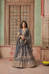 Buy stunning charcoal grey embroidered net lehenga online in USA with dupatta. Elevate your ethnic style with a tasteful collection of designer Anarkali, designer salwar suits, designer lehengas, sharara suits from Pure Elegance Indian clothing store in USA.-full view