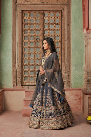Buy stunning charcoal grey embroidered net lehenga online in USA with dupatta. Elevate your ethnic style with a tasteful collection of designer Anarkali, designer salwar suits, designer lehengas, sharara suits from Pure Elegance Indian clothing store in USA.-side