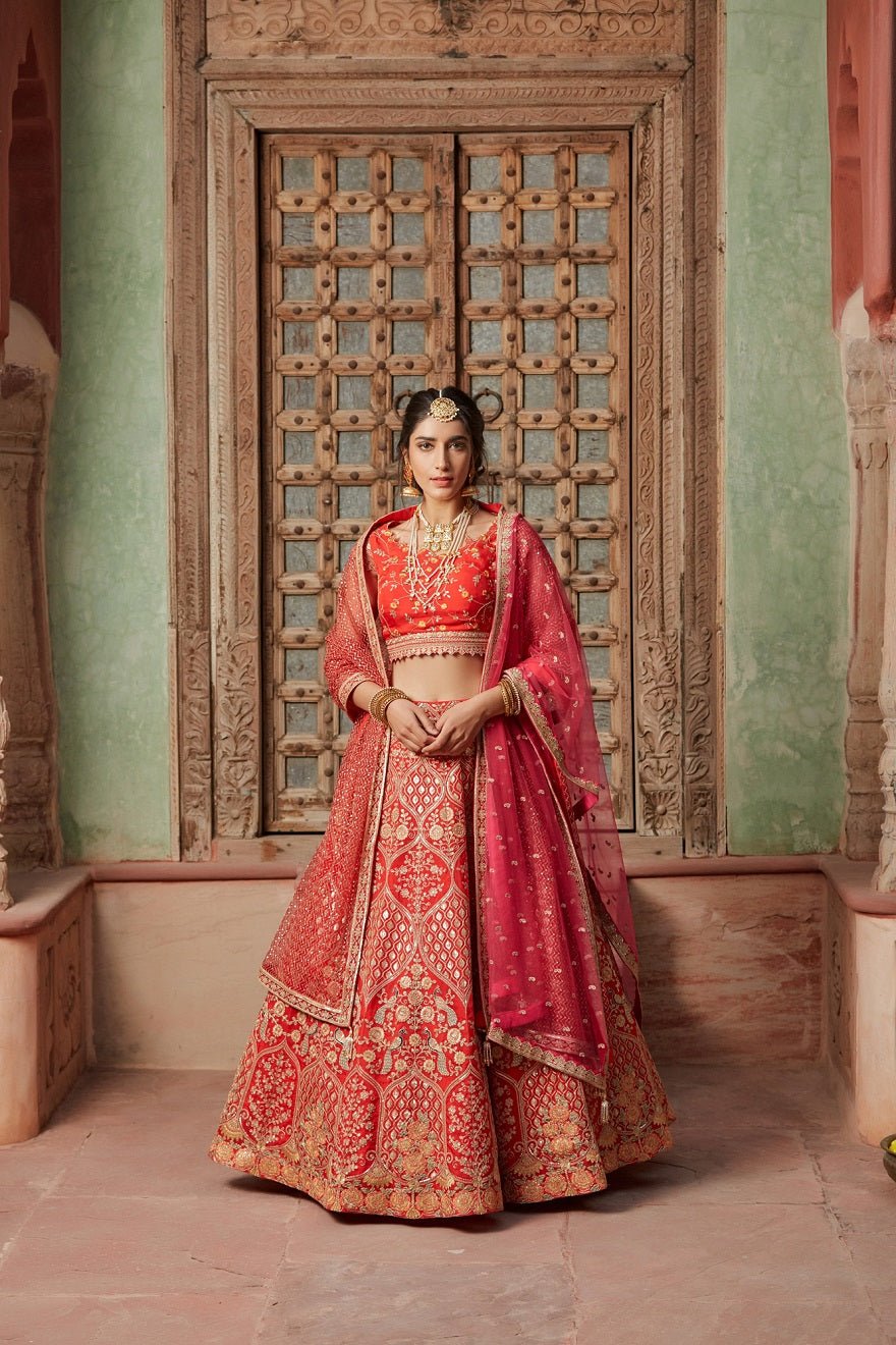 Shop gorgeous crimson red embroidered raw silk lehenga online in USA with pink dupatta. Elevate your ethnic style with a tasteful collection of designer Anarkali, designer salwar suits, designer lehengas, sharara suits from Pure Elegance Indian clothing store in USA.-full view