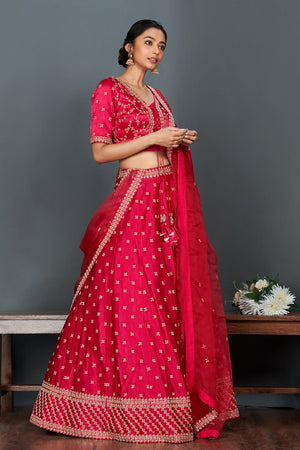 Shop stunning bright pink embroidered cotton lehenga set online in USA.  Make a fashion statement on festive occasions and weddings with designer suits, Indian dresses, Anarkali suits, palazzo suits, designer gowns, sharara suits from Pure Elegance Indian fashion store in USA.-side