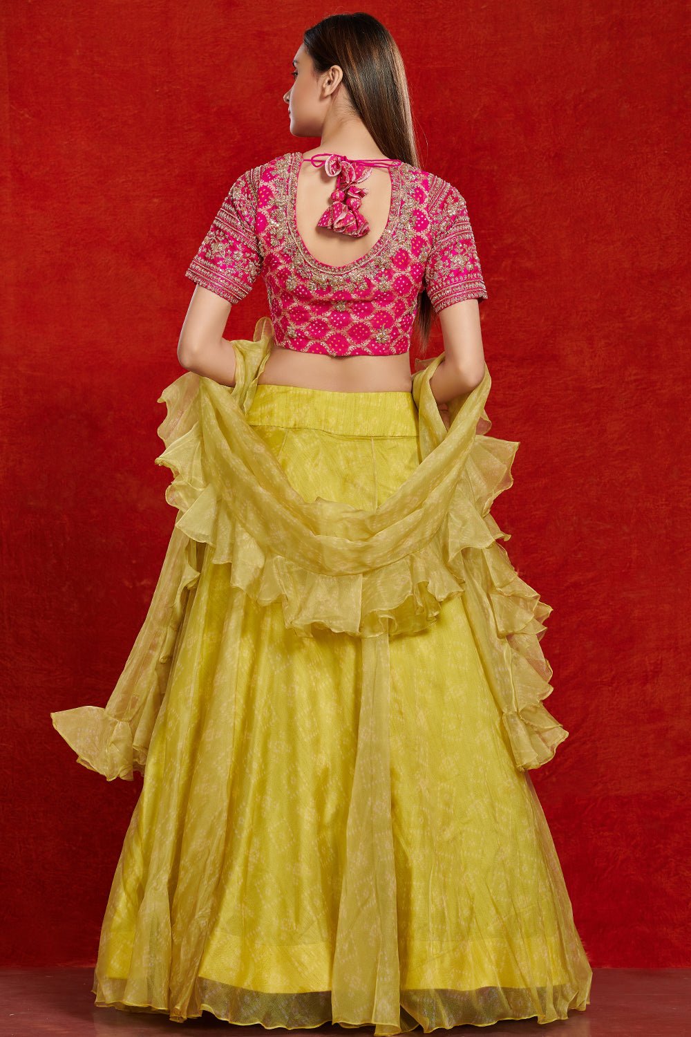 Buy beautiful pink and lime green organza lehenga set online in USA with ruffle dupatta.  Make a fashion statement on festive occasions and weddings with designer suits, Indian dresses, Anarkali suits, palazzo suits, designer gowns, sharara suits from Pure Elegance Indian fashion store in USA.-back