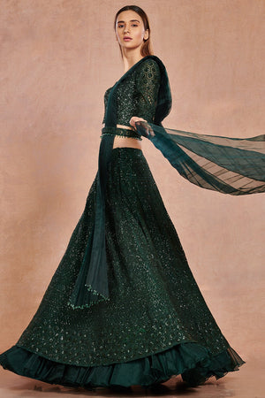 Buy beautiful bottle green shimmer and organza lehenga online in USA with belt.  Make a fashion statement on festive occasions and weddings with designer suits, Indian dresses, Anarkali suits, palazzo suits, designer gowns, sharara suits from Pure Elegance Indian fashion store in USA.-left