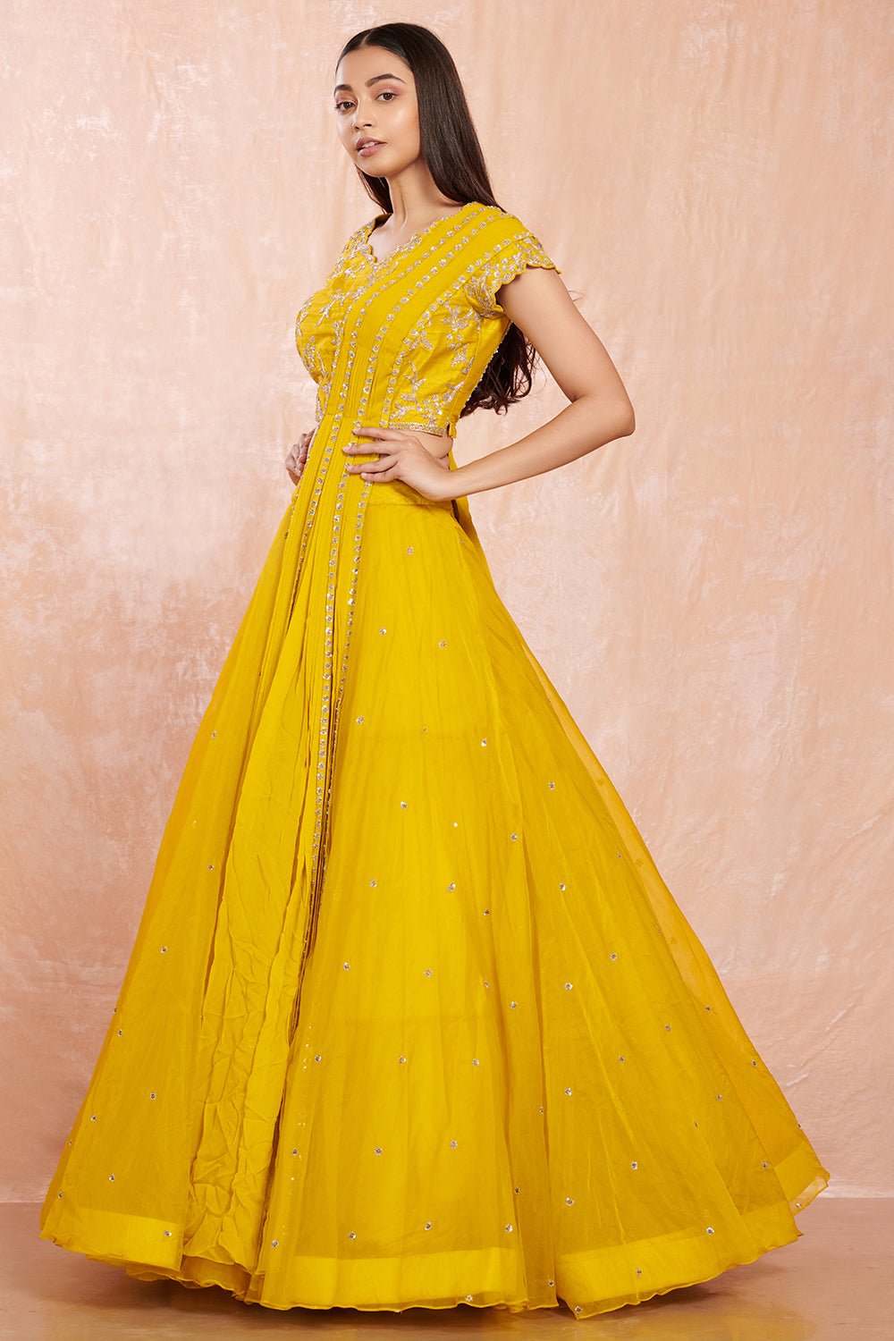 Buy stunning yellow designer net lehenga online in USA with silver floral embroidery.  Make a fashion statement on festive occasions and weddings with designer suits, Indian dresses, Anarkali suits, palazzo suits, designer gowns, sharara suits from Pure Elegance Indian fashion store in USA.-left
