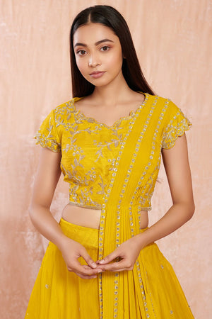 Buy stunning yellow designer net lehenga online in USA with silver floral embroidery.  Make a fashion statement on festive occasions and weddings with designer suits, Indian dresses, Anarkali suits, palazzo suits, designer gowns, sharara suits from Pure Elegance Indian fashion store in USA.-closeup