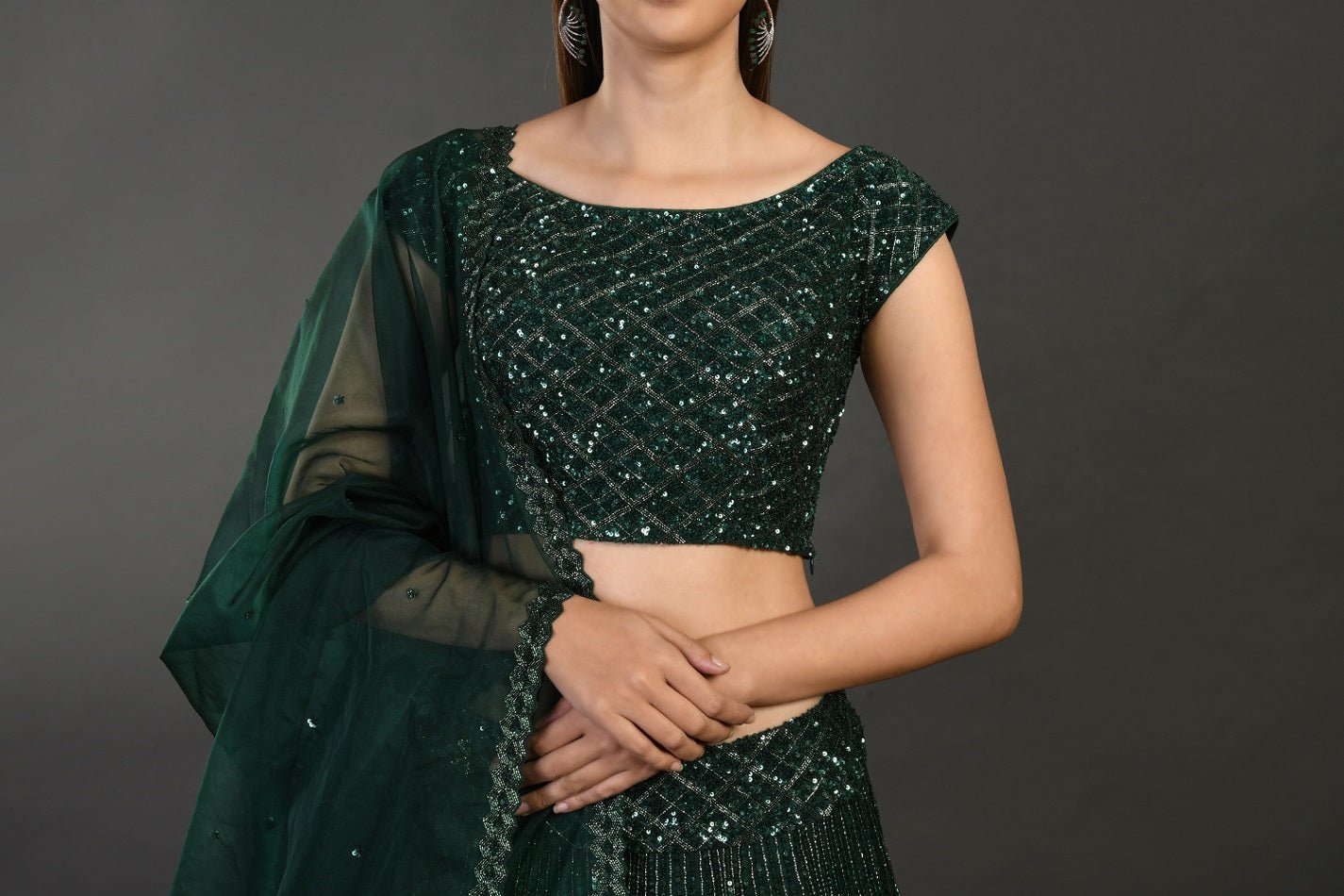 Buy beautiful bottle green embroidered designer lehenga online in USA with dupatta. Dazzle on weddings and special occasions with exquisite Indian designer dresses, sharara suits, Anarkali suits, wedding lehengas from Pure Elegance Indian fashion store in USA.-closeup