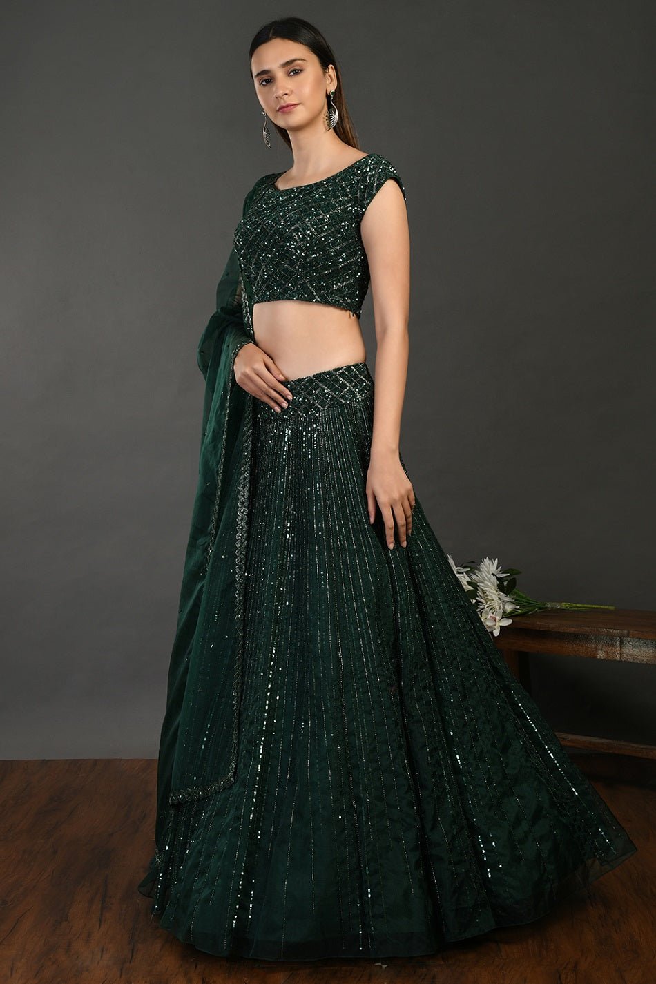 Buy beautiful bottle green embroidered designer lehenga online in USA with dupatta. Dazzle on weddings and special occasions with exquisite Indian designer dresses, sharara suits, Anarkali suits, wedding lehengas from Pure Elegance Indian fashion store in USA.-side