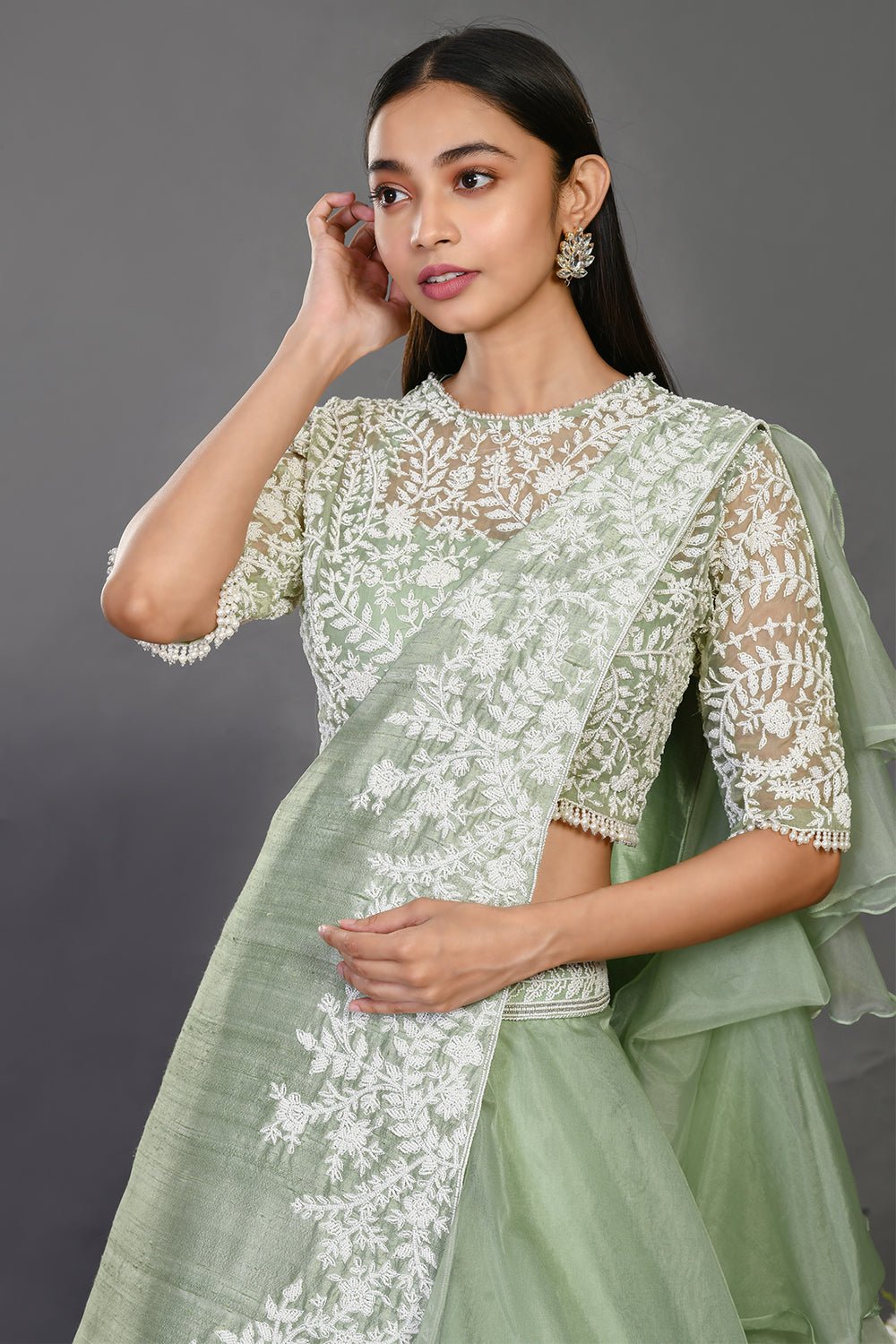 Shop stunning mint green embroidered designer lehenga online in USA with dupatta. Dazzle on weddings and special occasions with exquisite Indian designer dresses, sharara suits, Anarkali suits, wedding lehengas from Pure Elegance Indian fashion store in USA.-closeup